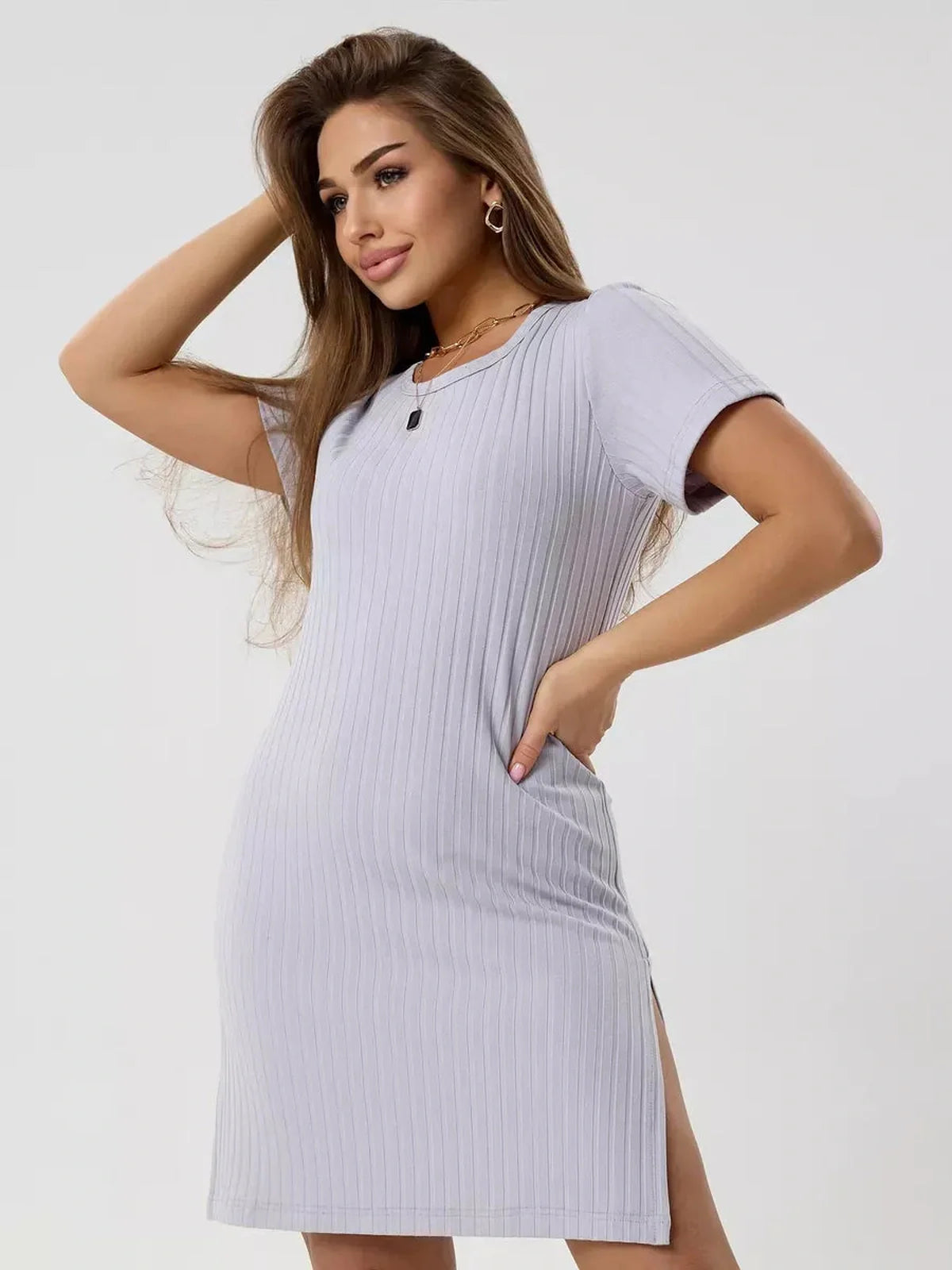 Model wearing a soft ribbed Cloudline Mini dress in light purple, showcasing comfort and style with short sleeves.