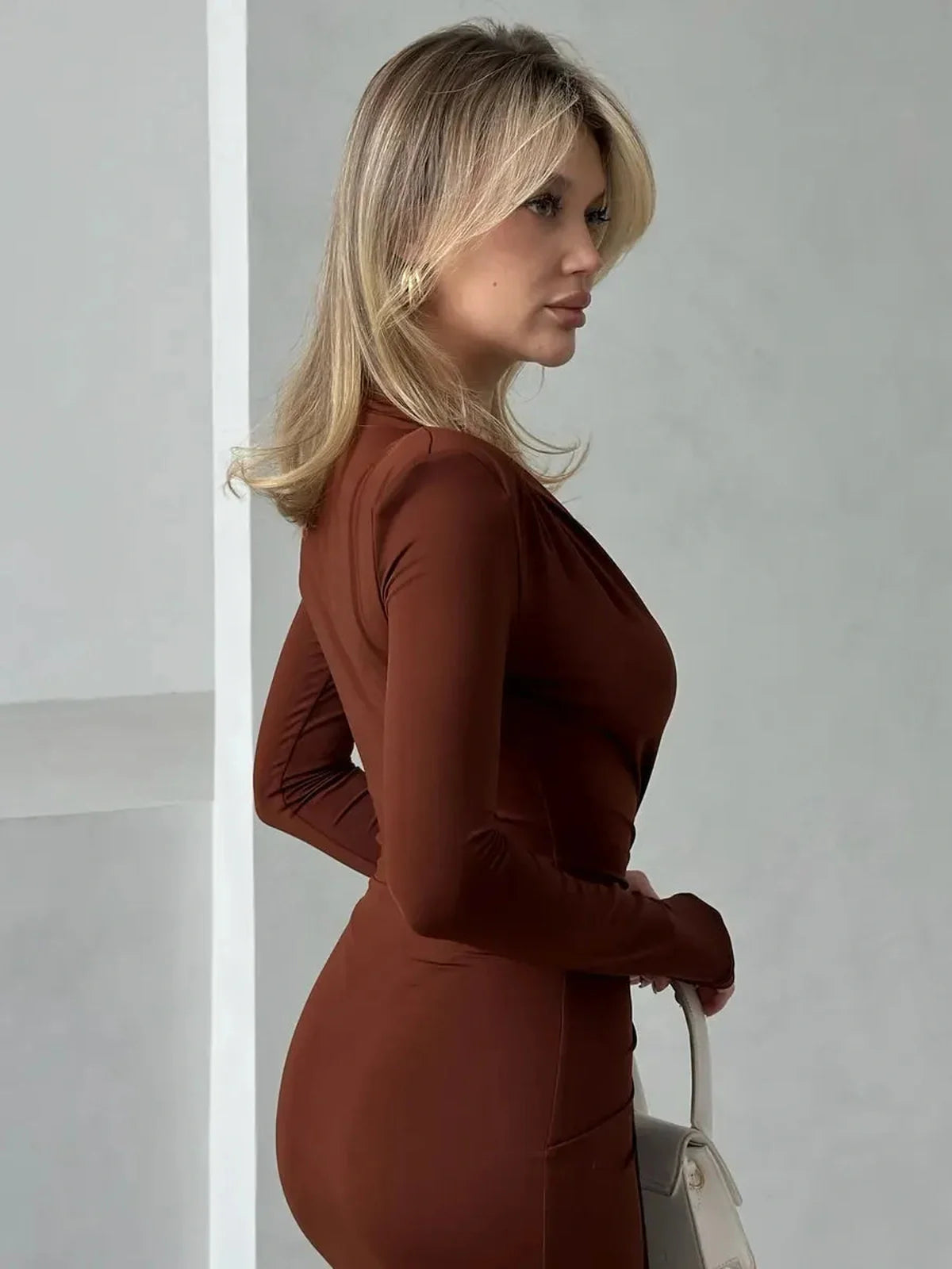 Sienna Plunge Maxi Dress in rich brown hue, showcasing deep V-neckline and sleek silhouette for elegant styling.