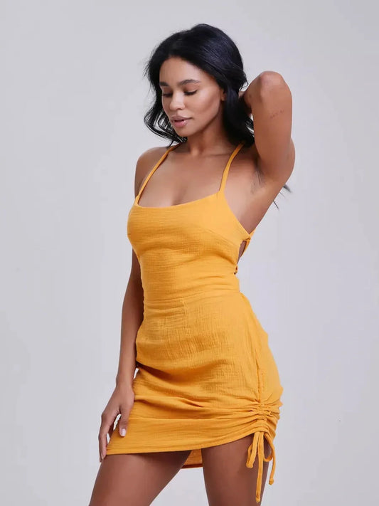 Citrus Rush mini dress in vibrant yellow, featuring adjustable crisscross straps and textured crinkle fabric.