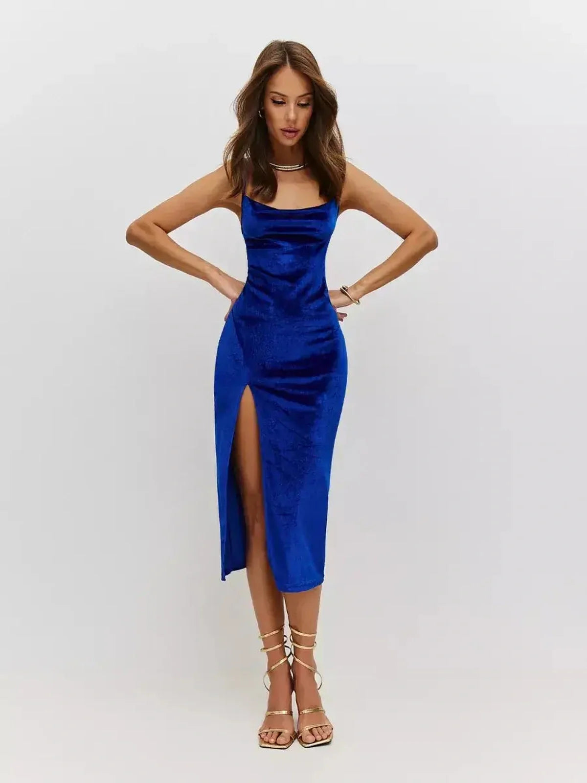 Sleek sapphire blue midi dress in plush velvet with cowl neckline and thigh-high slit, perfect for evening elegance.