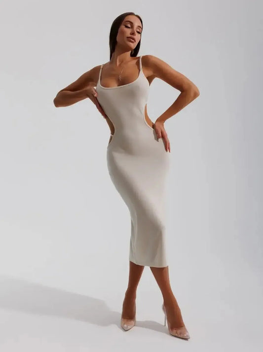 Elegant beige midi dress with sculpted side cutouts, showcasing a body-hugging silhouette and spaghetti straps.