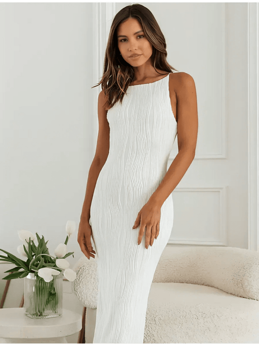 Ivory Wave Maxi Dress featuring sculpted texture and minimalist elegance on a model against a light backdrop.