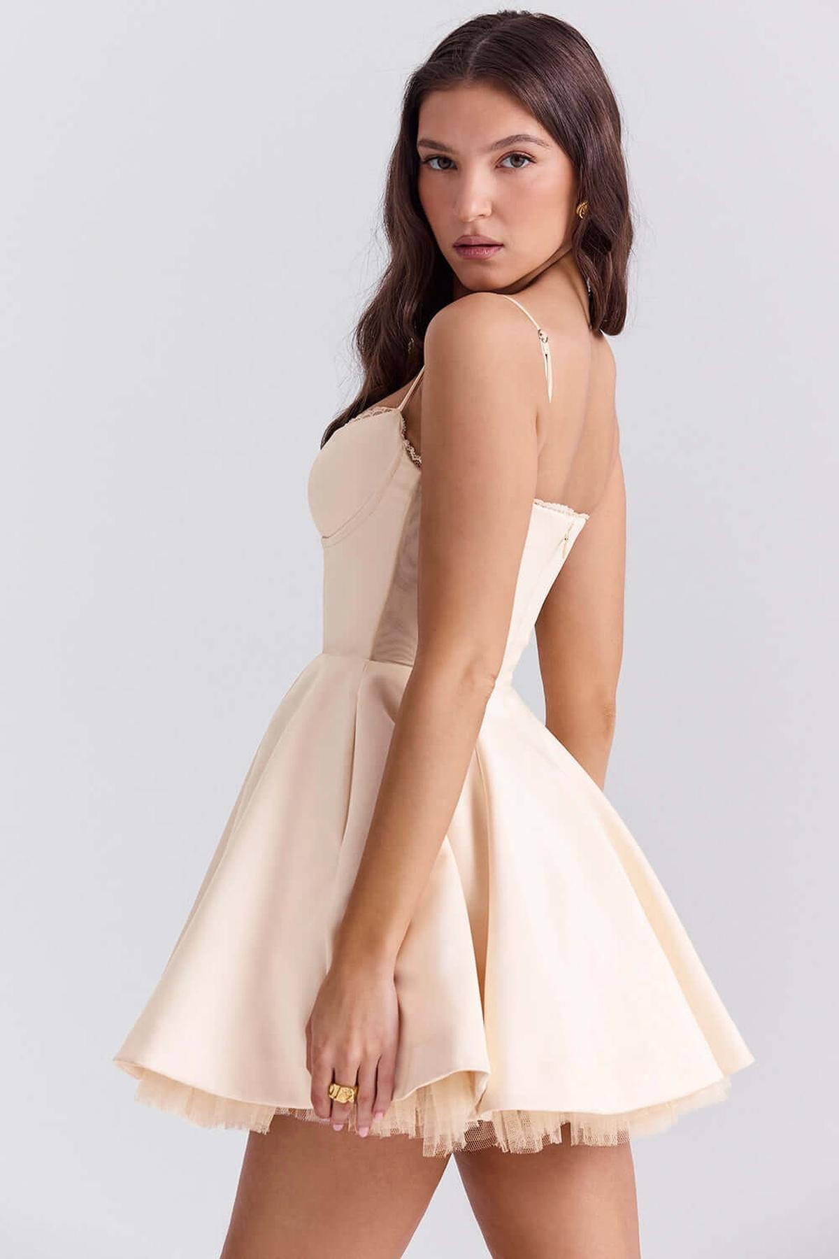 Elegant Inez Mini Dress in a soft beige, featuring a fluffy skirt and delicate straps, perfect for summer and special occasions.