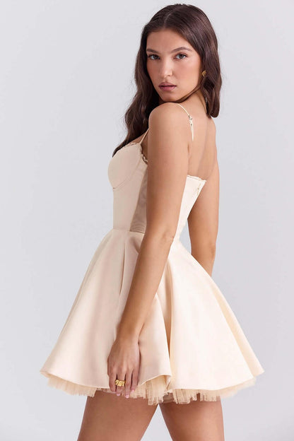 Elegant Inez Mini Dress in a soft beige, featuring a fluffy skirt and delicate straps, perfect for summer and special occasions.
