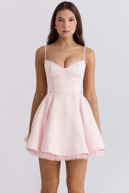 Inez Mini Dress in soft pink with a playful flared skirt, perfect for summer events and cocktail parties.