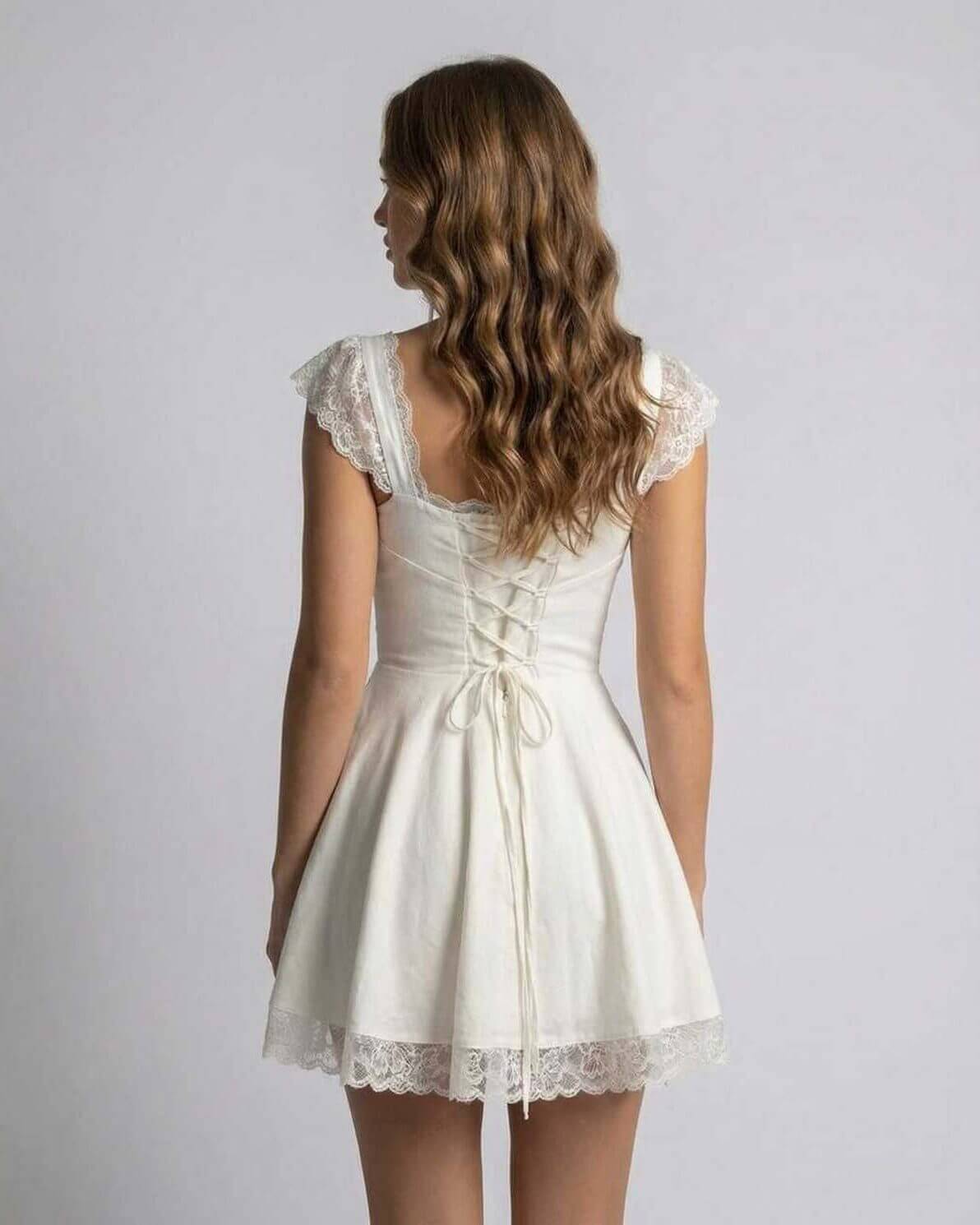 Isla Mini Dress by Lauven showcasing a back view with lace details and a slim fit silhouette in pristine white.