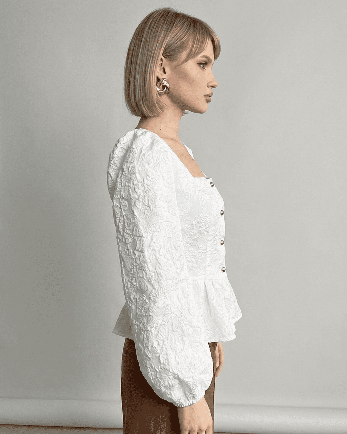 Ivory Corset Top by Lauven, featuring jacquard fabric and puff sleeves, showcasing a refined and elegant look.
