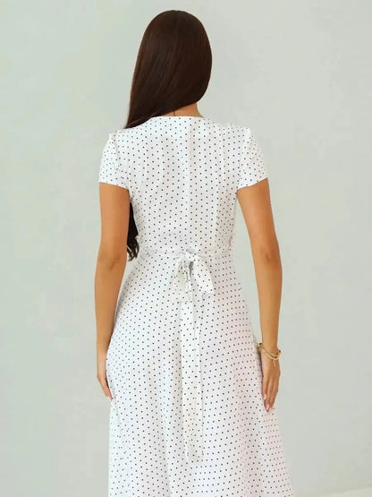 Back view of the Ivory Dots Maxi Dress showcasing its wrap-style silhouette and polka dot pattern.