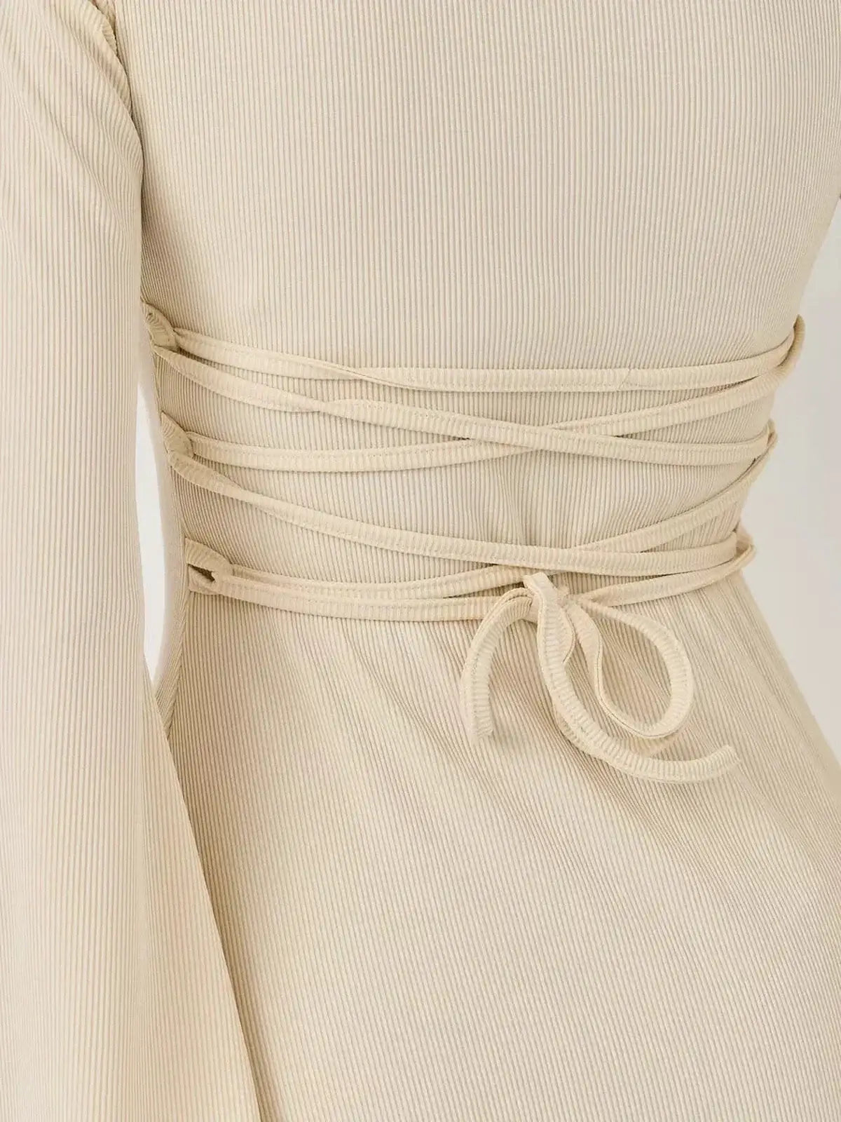 Back detail of Ivory Flare mini dress by Lauven featuring intricate lace-up design and ribbed texture.