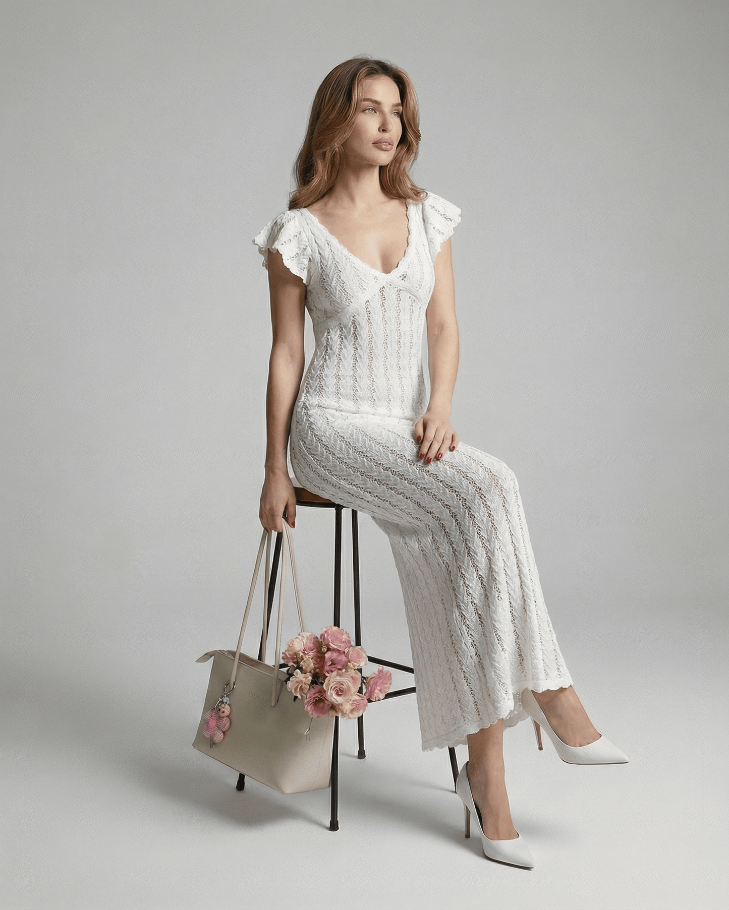 Ivory Lace Maxi by Lauven, featuring a V-neck bodycon design with ruffle sleeves and floral handbag.