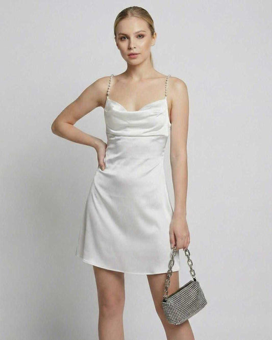 Ivory Mini Dress by Lauven, featuring satin fabric, draped neck, and pearl strap detail.
