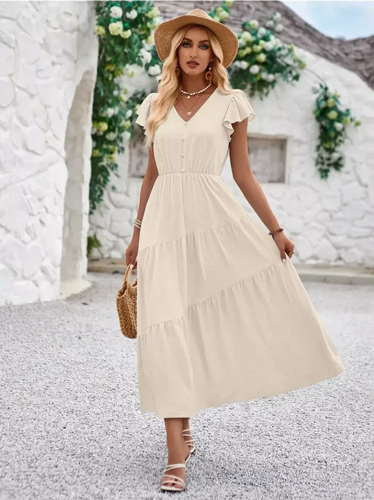 Ivory Solstice summer dress with flutter sleeves and tiered skirt, perfect for weddings and casual outings.