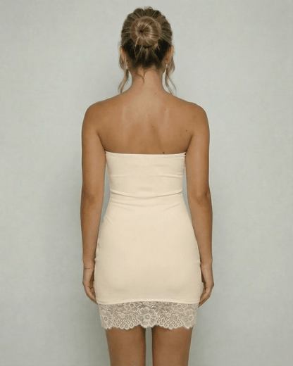 Ivorya Mini Dress by Lauven, showing the back view of a strapless ivory sheath dress with lace hem detail.