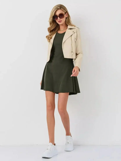 Stylish model in Ivy Bell mini dress featuring flared bell sleeves and a chic biker jacket by Lauven.