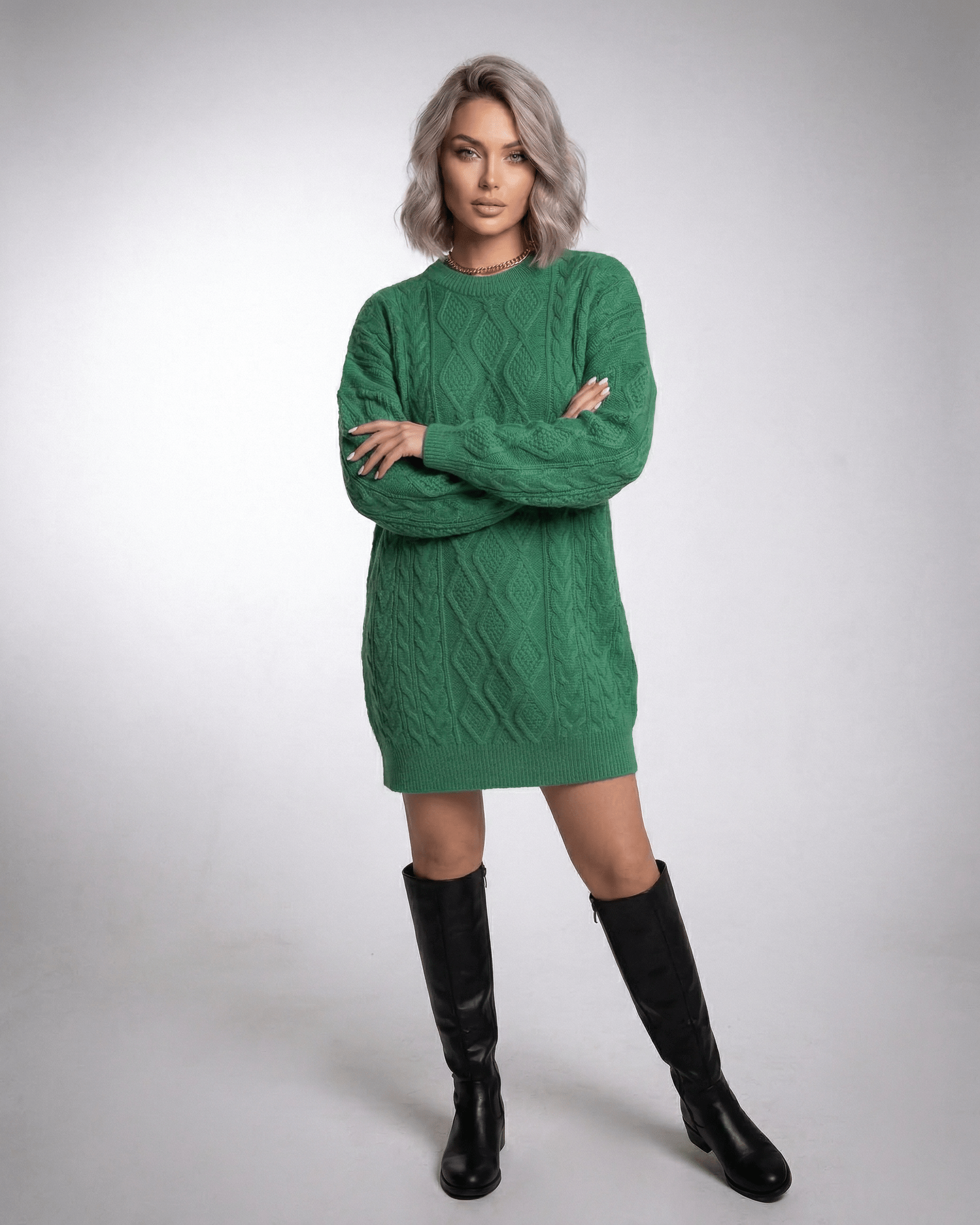 Model wearing Ivy Mini Dress in Emerald Green Cable Knit by Lauven, showcasing a loose fit and ribbed trims.