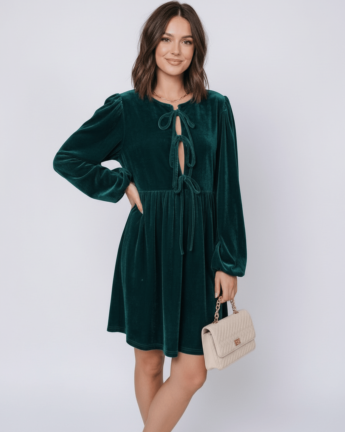 Jade Mini Dress by Lauven - Elegant emerald velvet dress with lantern sleeves and plush texture, styled with a chic handbag.