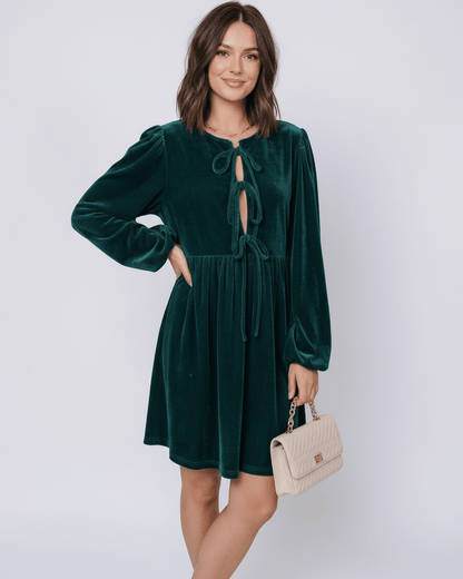 Jade Mini Dress by Lauven - Elegant emerald velvet dress with lantern sleeves and plush texture, styled with a chic handbag.
