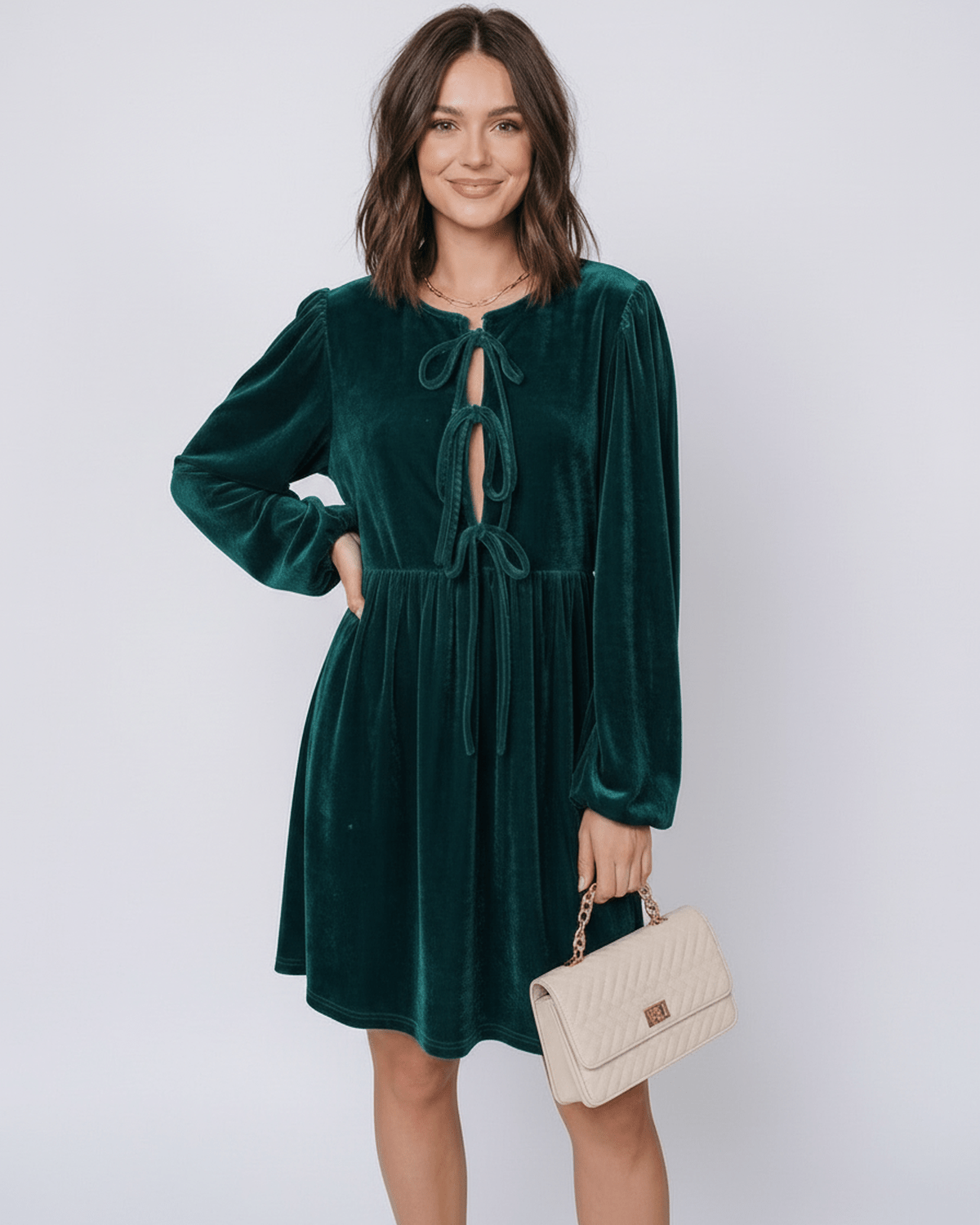 Elegant model wearing a Jade Mini Dress by Lauven, featuring velvet fabric, lantern sleeves, and a drawstring front.