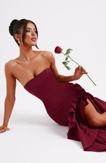 Jasmine Women’s Dress in burgundy with strapless design, ruffle detail and high leg slit, perfect for formal occasions.