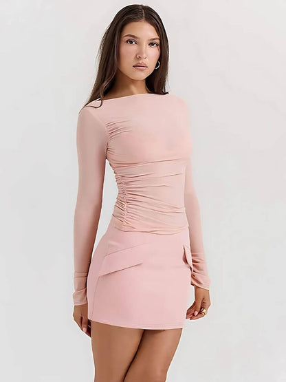 Juno Mini Dress in soft pink, featuring long sleeves and ruched detailing, perfect for summer and cocktail events.