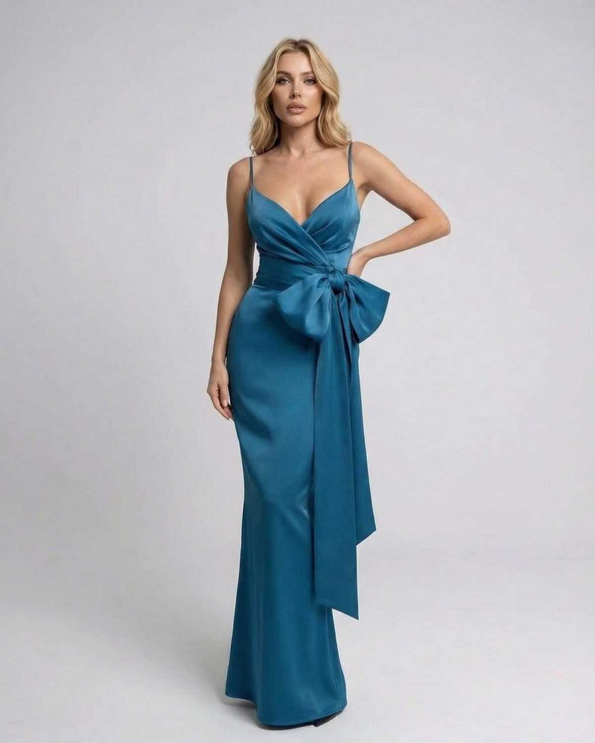 Lauven Laguna Maxi Dress in solid teal with asymmetrical design and statement bow detail.