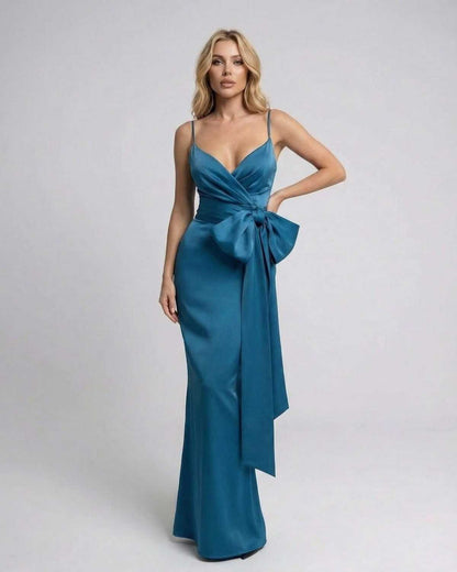 Lauven Laguna Maxi Dress in solid teal with asymmetrical design and statement bow detail.
