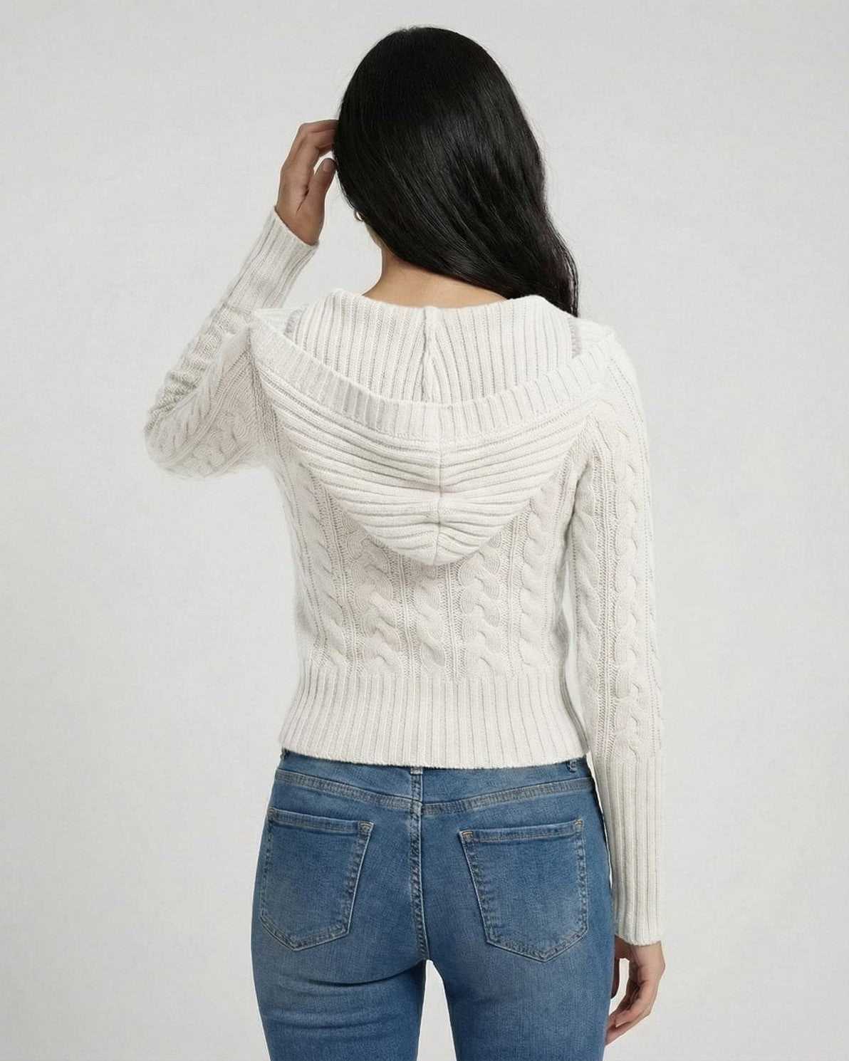 Back view of a woman wearing the Lauven Alba Sweater, a hooded cable knit slim fit in crisp white.