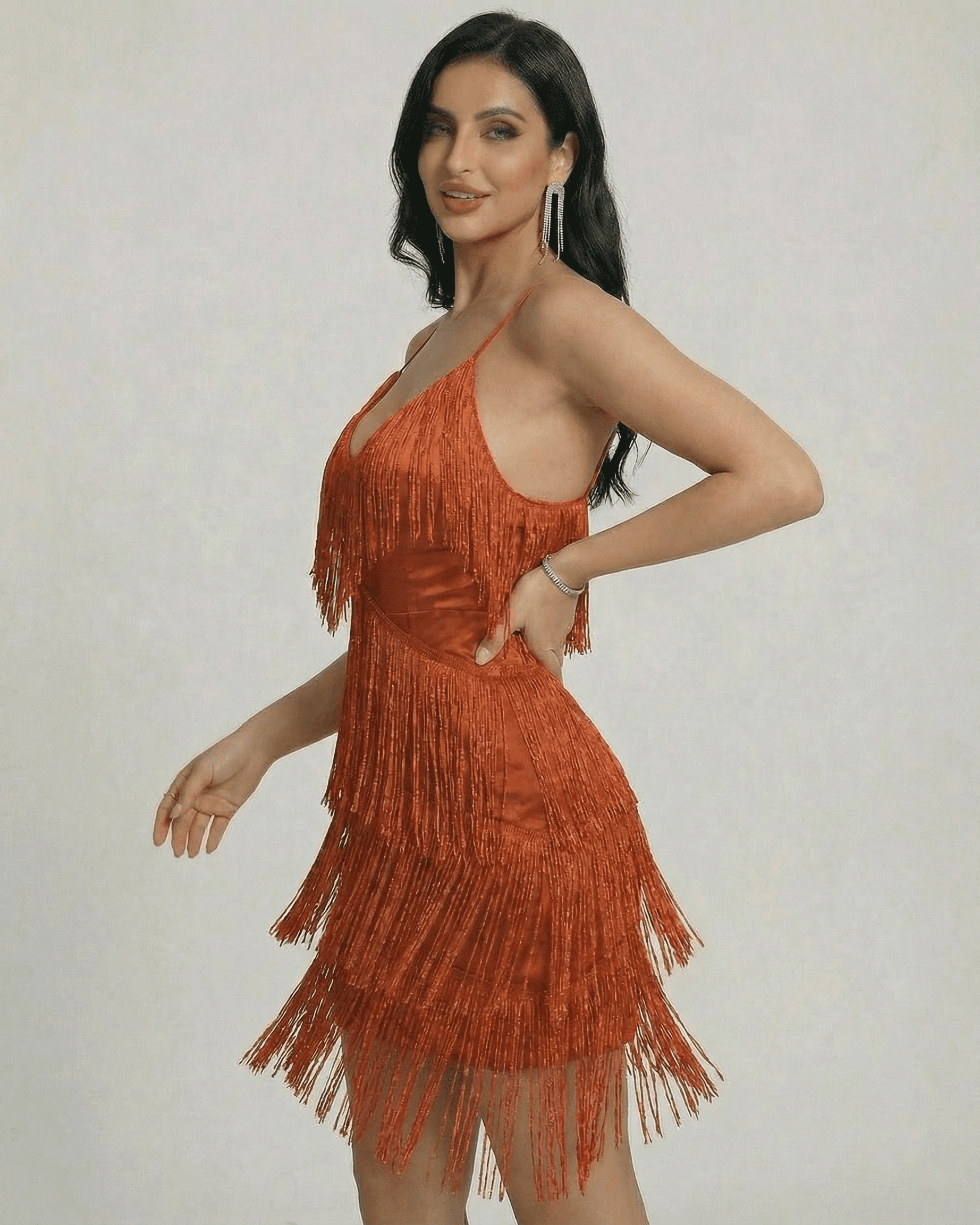 Lauven Amber Mini Dress featuring fringe detailing and a sleek V-neck silhouette in a warm amber tone.