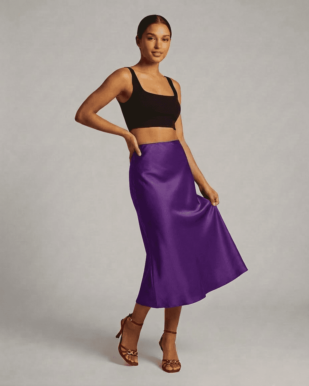 Model wearing the Amethyst Midi Skirt by Lauven, showcasing the elegant satin mermaid design in vibrant purple.