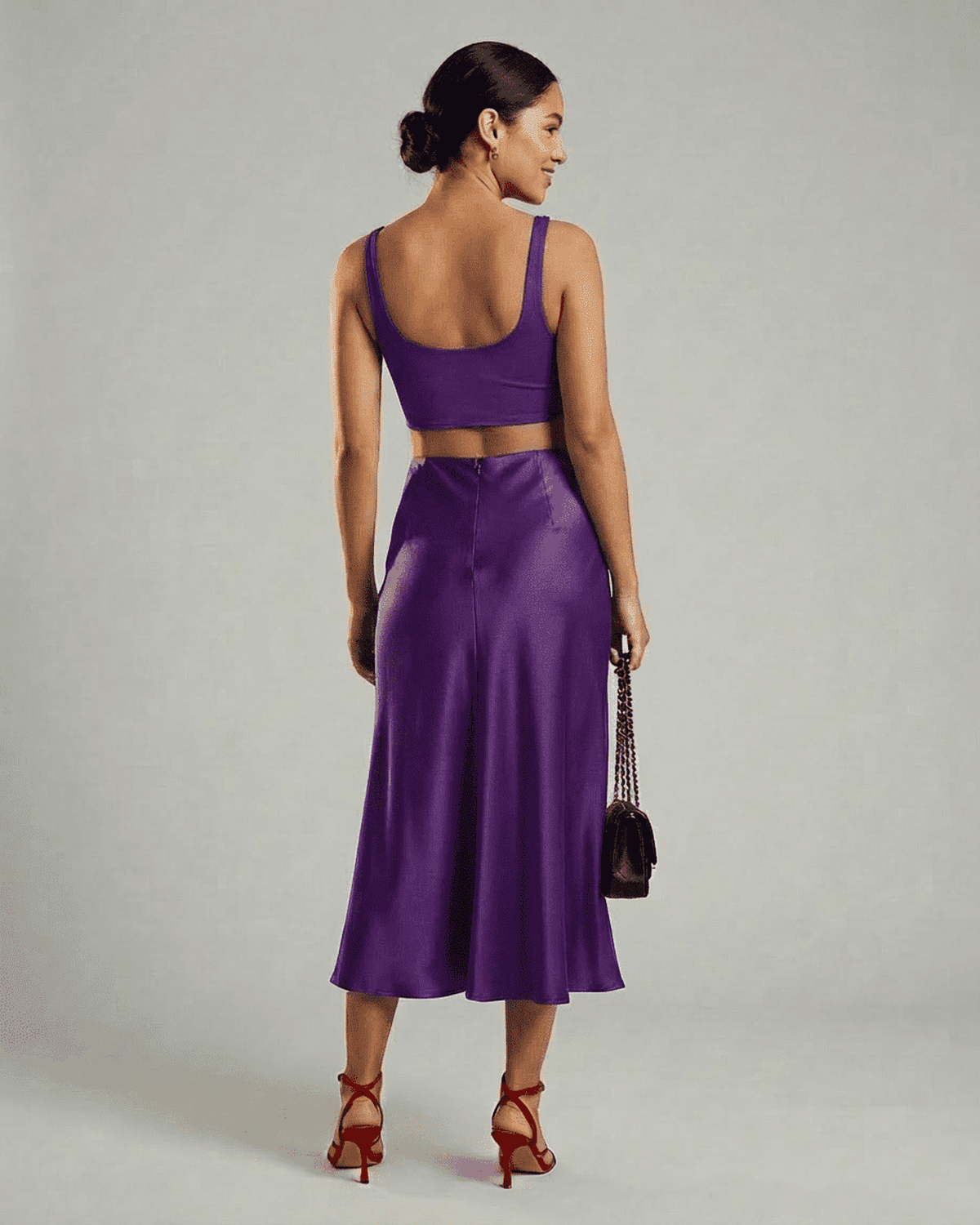 Back view of a model wearing the Lauven Amethyst Midi Skirt paired with a crop top.