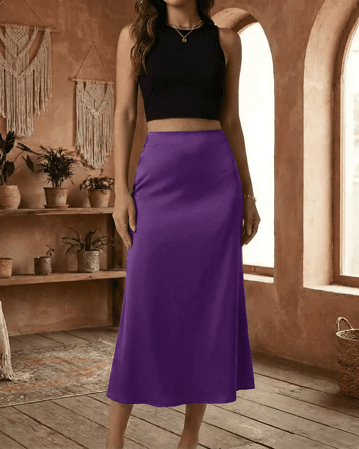 Model showcasing the Amethyst Midi Skirt by Lauven in vibrant purple satin, elegantly styled with a black crop top.