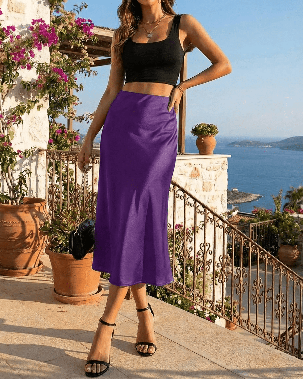 Model showcases the Amethyst Midi Skirt by Lauven, featuring a vibrant purple satin design in an elegant setting.