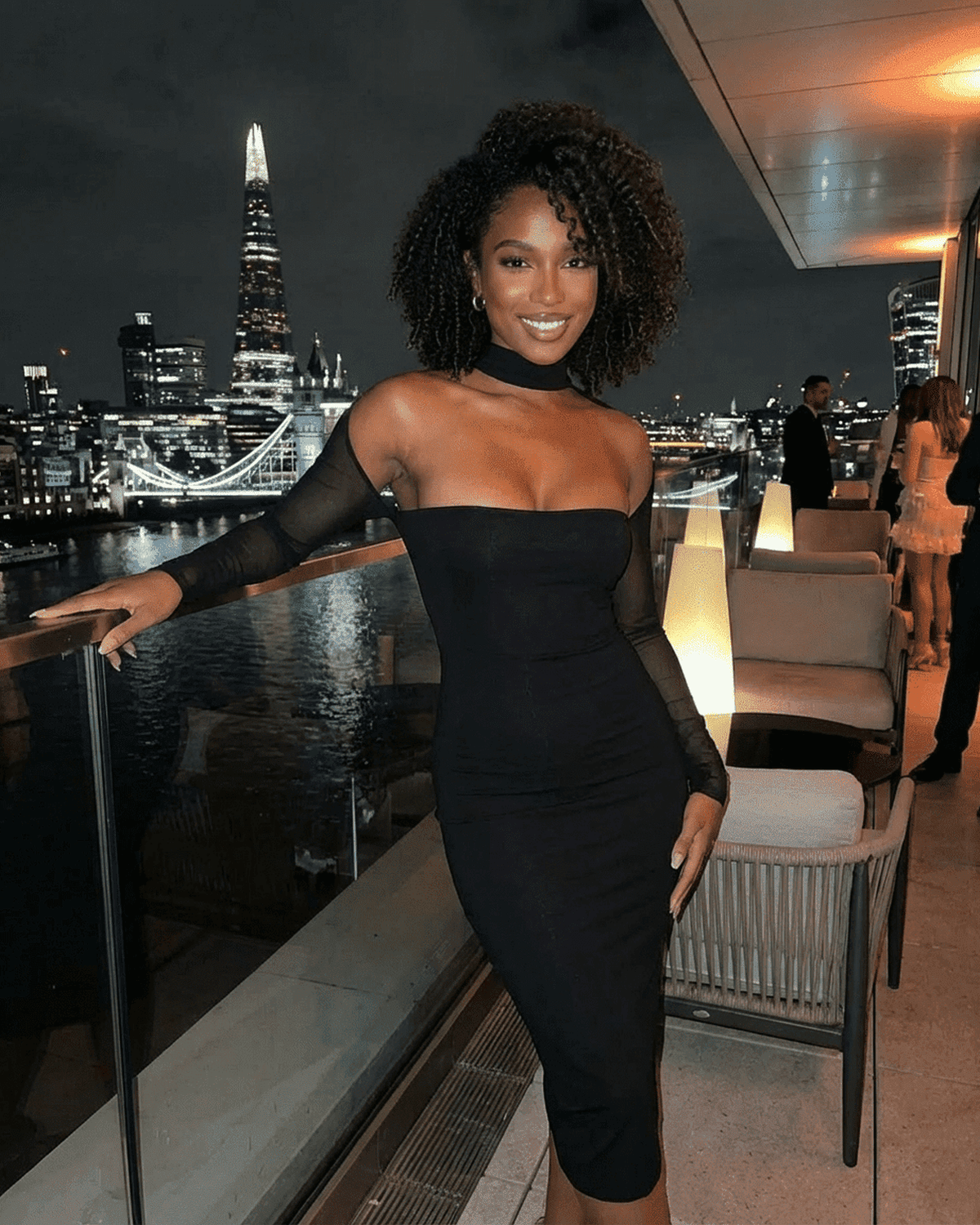 Arden Midi Dress by Lauven showcased in a chic evening setting with city skyline background.