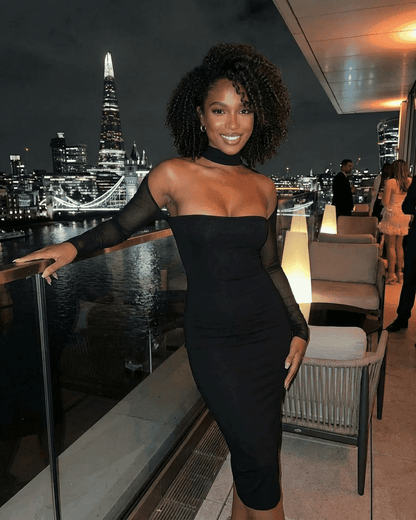 Arden Midi Dress by Lauven showcased in a chic evening setting with city skyline background.