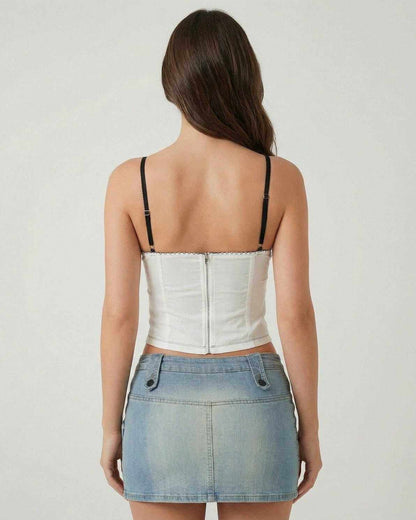 Back view of a woman wearing the Arden Top by Lauven, showcasing its white fabric and black straps.