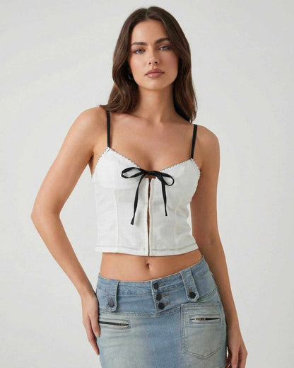 Arden Top by Lauven – White camisole with black bow detail, featuring delicate straps and a stylish silhouette.