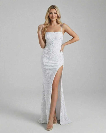 Model wearing the Aria Maxi Dress by Lauven, a white sequin floor-length gown with a thigh-high slit.