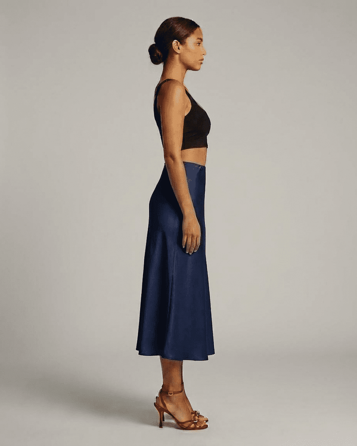 Astra Midi Skirt by Lauven in deep navy blue, showcasing elegant mermaid silhouette from side view.