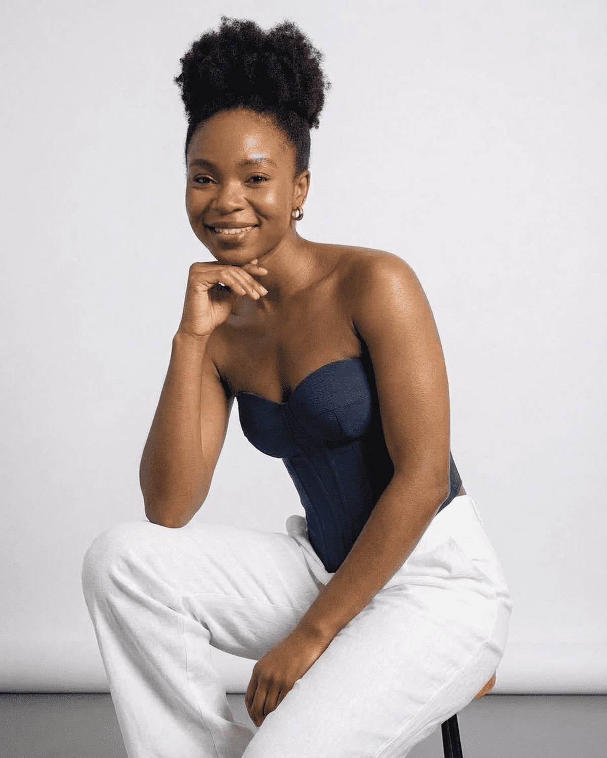 Model wearing the Atlas Corset Top by Lauven, a sleek navy faux denim bustier for a sophisticated look.