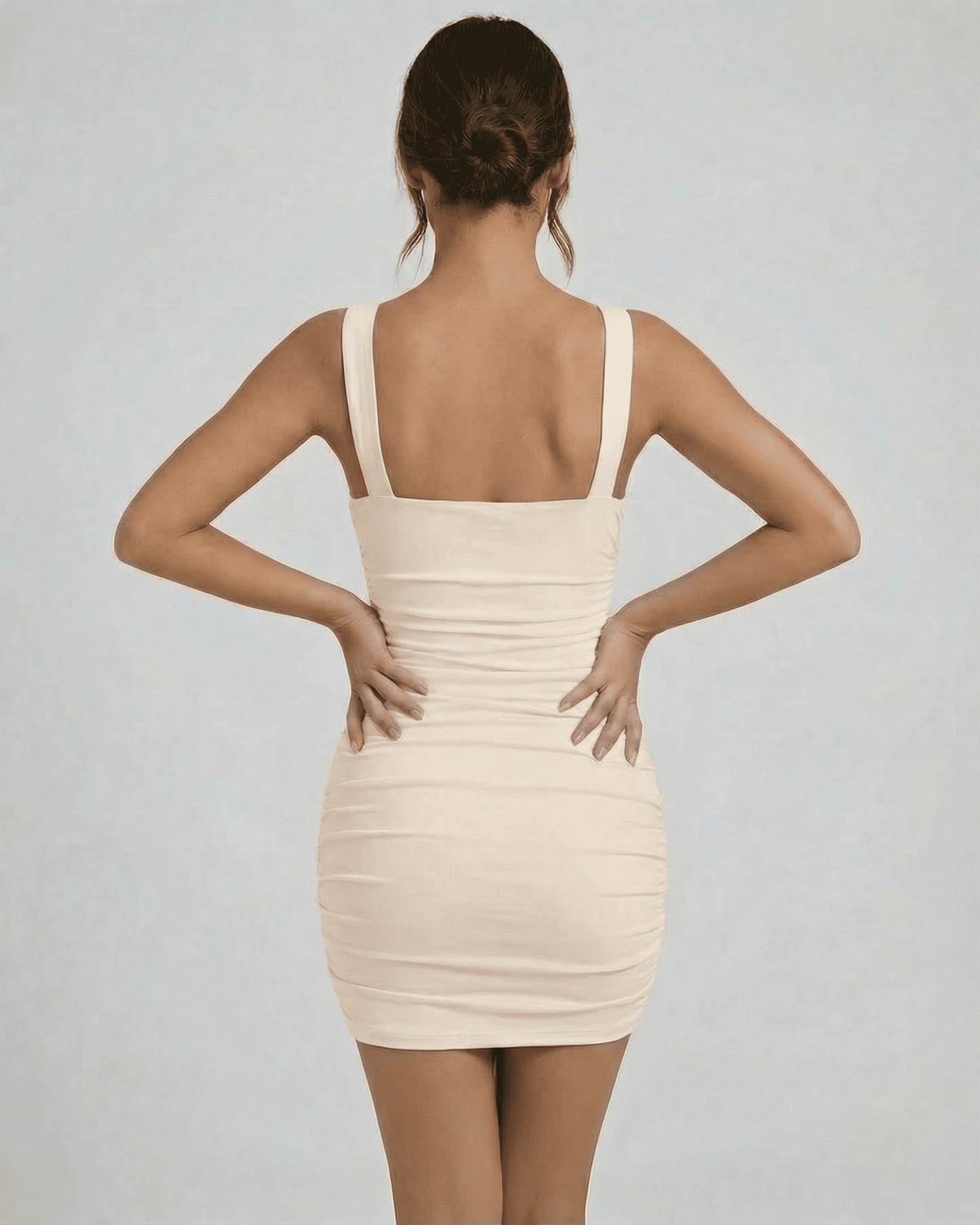 Aurelia Mini Dress by Lauven, showcasing asymmetrical neck and ruched detail from the back view.