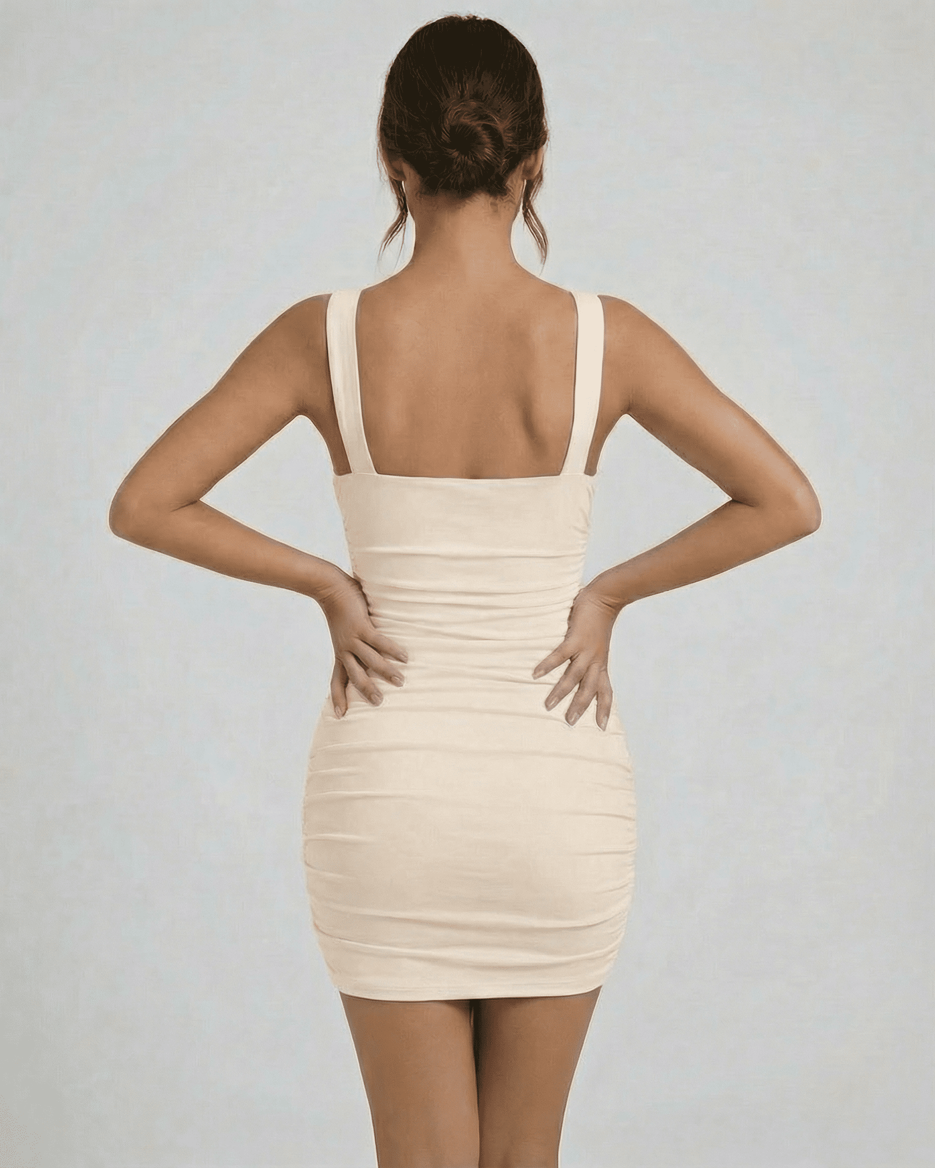 Aurelia Mini Dress by Lauven, showcasing asymmetrical neck and ruched detail from the back view.