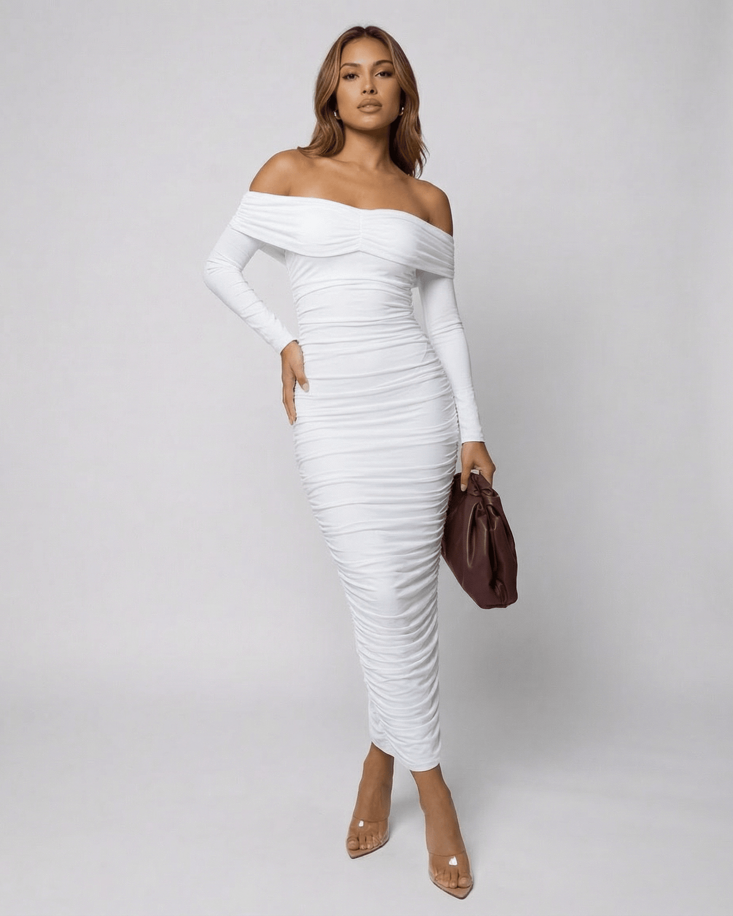 Model showcasing the Auriel Midi Dress by Lauven, an off-the-shoulder, ruched white midi dress.