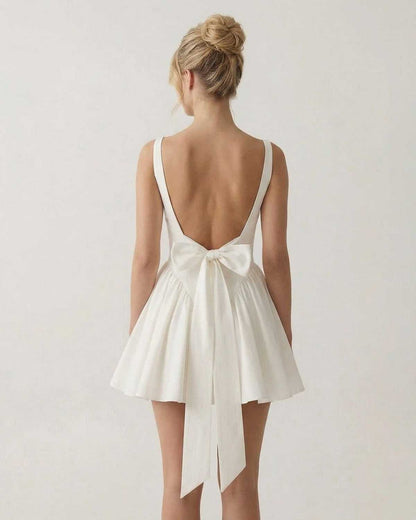 Aurora Mini Dress by Lauven featuring a square neck backless design and bow detail on the back.