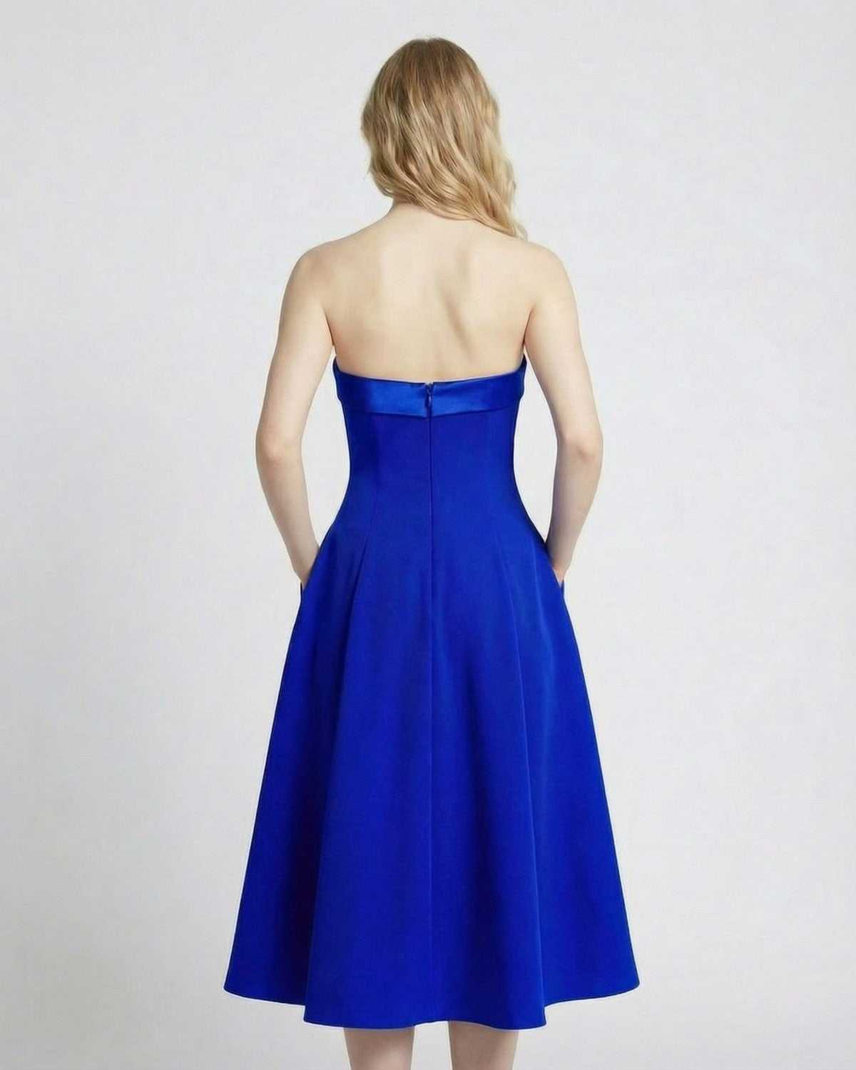 Back view of the Azura Midi Dress by Lauven, featuring a strapless design and elegant silhouette with pockets.