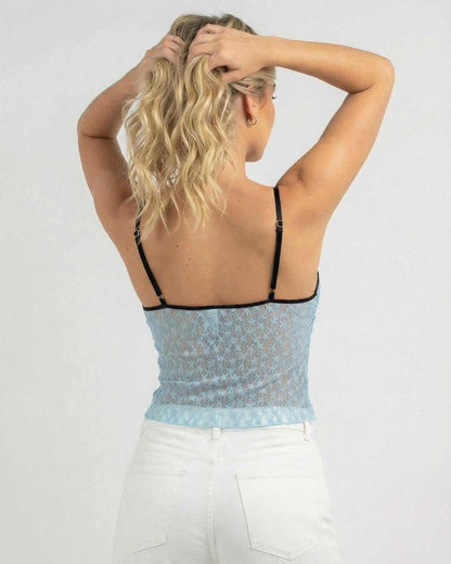 Back view of model wearing the Azure Lace Top by Lauven, showcasing its vintage lace trim and slim fit design.
