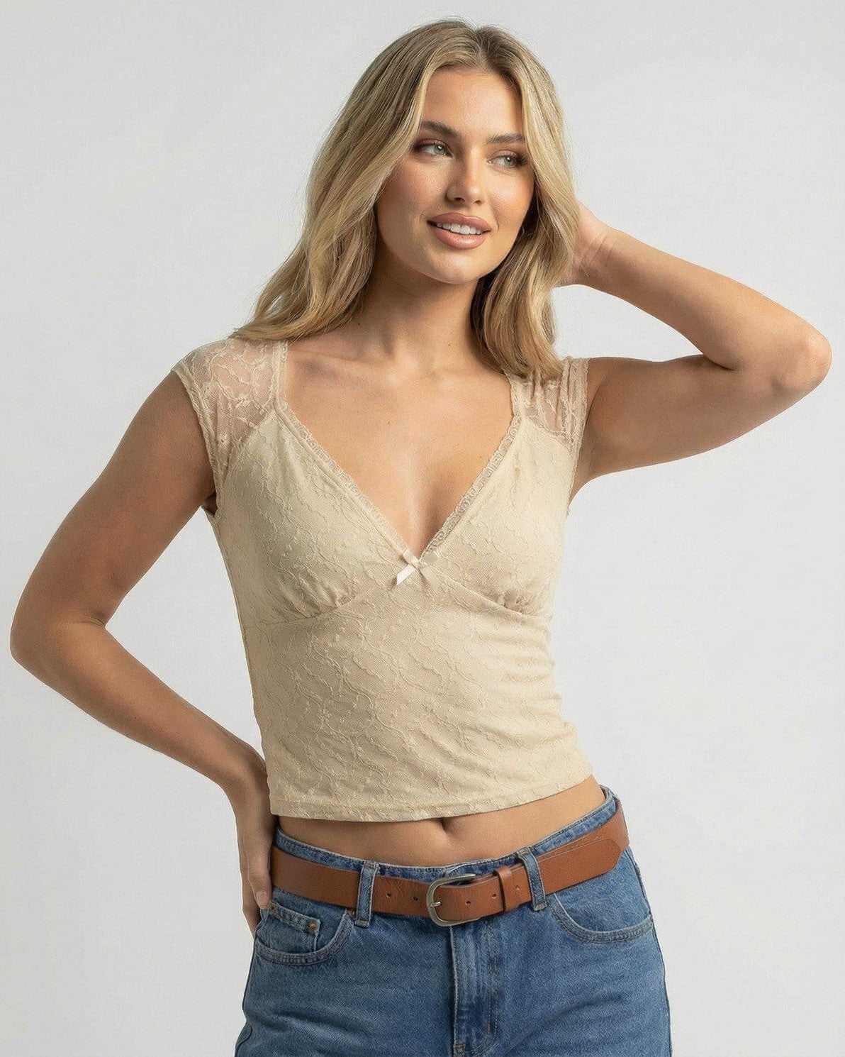 Beige Lace Top by Lauven – Women's slim fit V-neck crop tee featuring lace texture and bow accent.