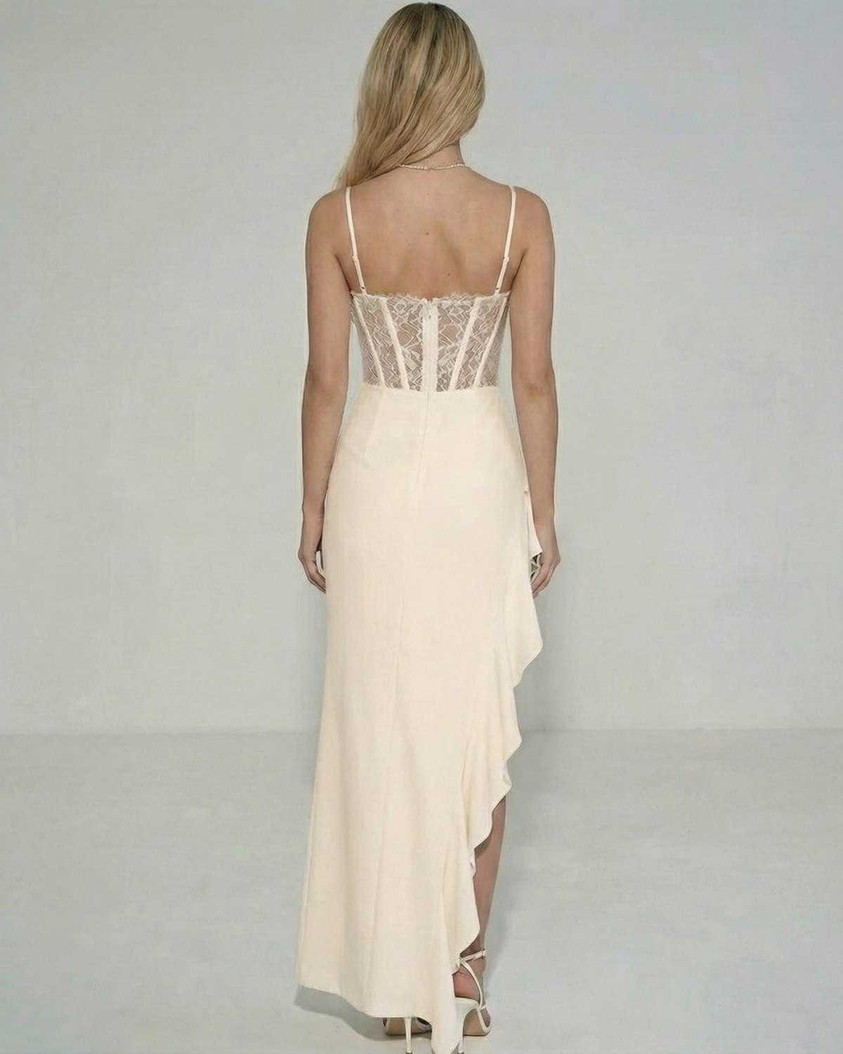 Back view of Lauven Blush Maxi Dress showcasing sheer lace bodice and ruffled asymmetrical skirt.
