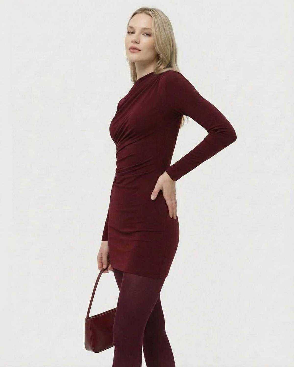 Model wearing Lauven Bordeaux Mini Dress. Long sleeve bodycon mini dress in deep wine tone with applique detail.