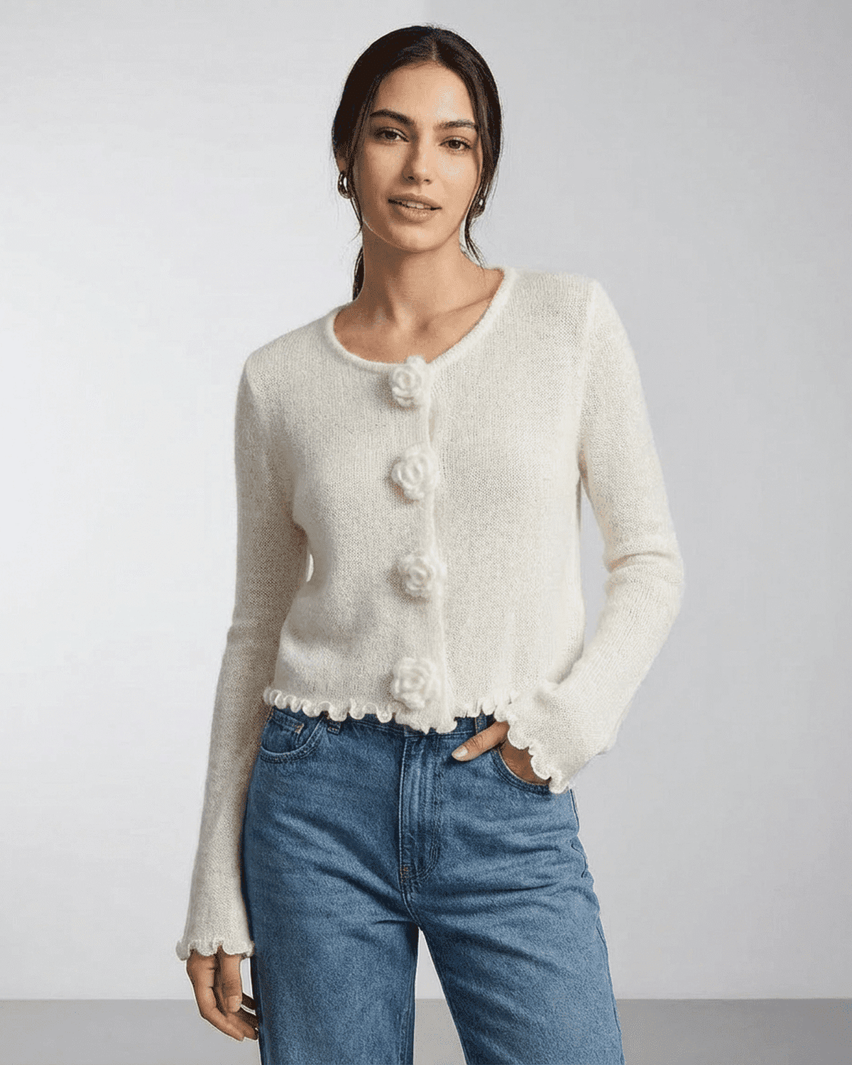 Camellia Cardigan by Lauven featuring floral buttons and a soft knit texture on a woman.