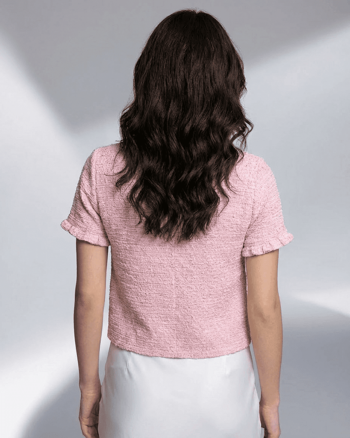 Camellia Cardigan by Lauven in pink, showcasing the back view with short sleeves and textured fabric.